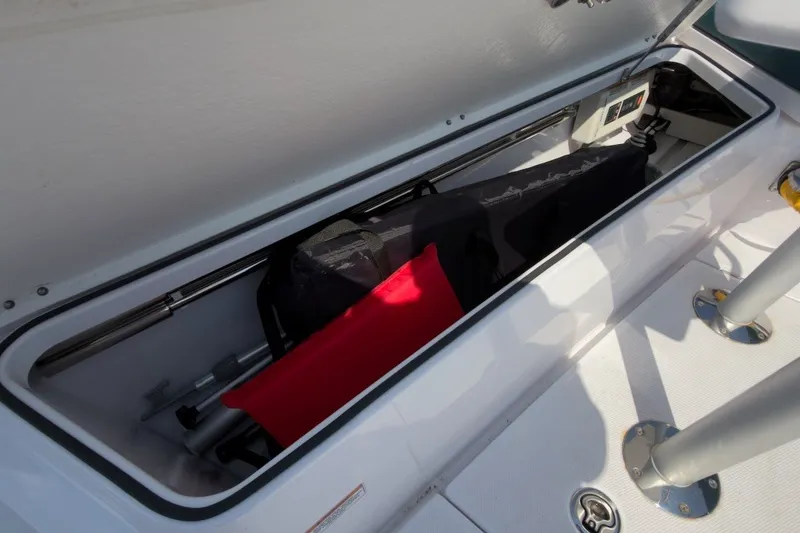 Slide: The Image of Storage compartment on 2023 Axopar 28 Cabin boat, featuring organized equipment and accessories. - 38