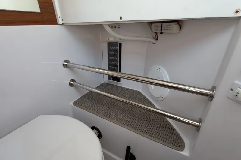 Slide: The Image of Interior of 2023 Axopar 28 Cabin boat, featuring stainless steel rails and control panel. - 37