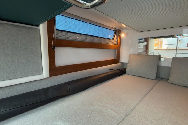 Slide: The Image of 2023 Axopar 28 Cabin interior with cozy seating and modern design. - 25