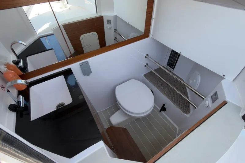 Slide: The Image of Modern bathroom interior of 2023 Axopar 28 Cabin boat, featuring sleek design and amenities. - 34