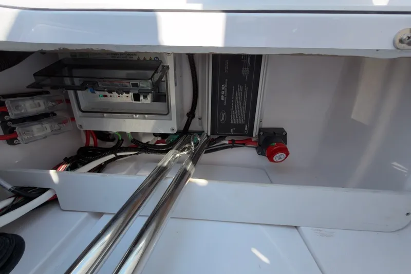 Slide: The Image of Electrical components inside a 2023 Axopar 28 Cabin boat, featuring wiring and control panel. - 40