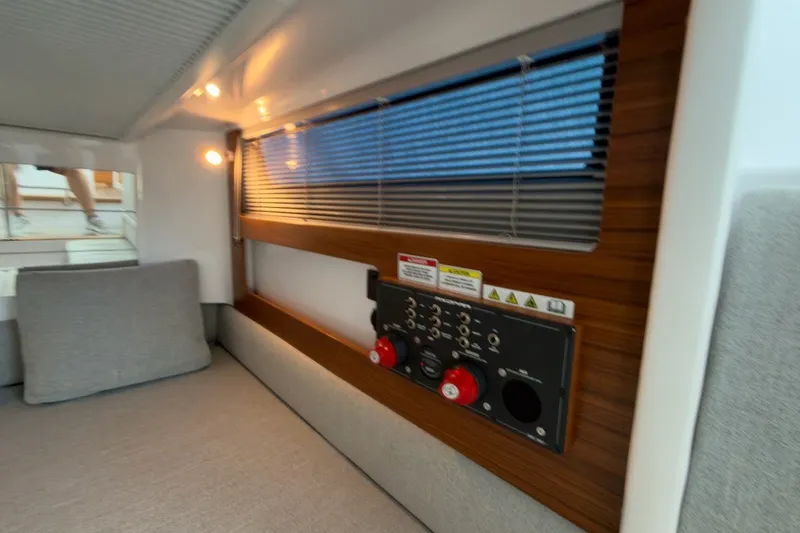 Slide: The Image of 2023 Axopar 28 Cabin interior with control panel and modern lighting. - 24