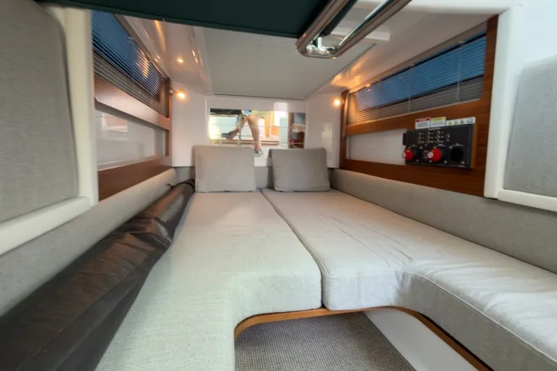 Slide: The Image of 2023 Axopar 28 Cabin interior with comfortable seating and modern design. - 23