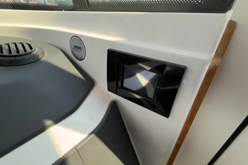 Slide: The Image of Interior detail of 2023 Axopar 28 Cabin boat, featuring modern design elements and ventilation system. - 29