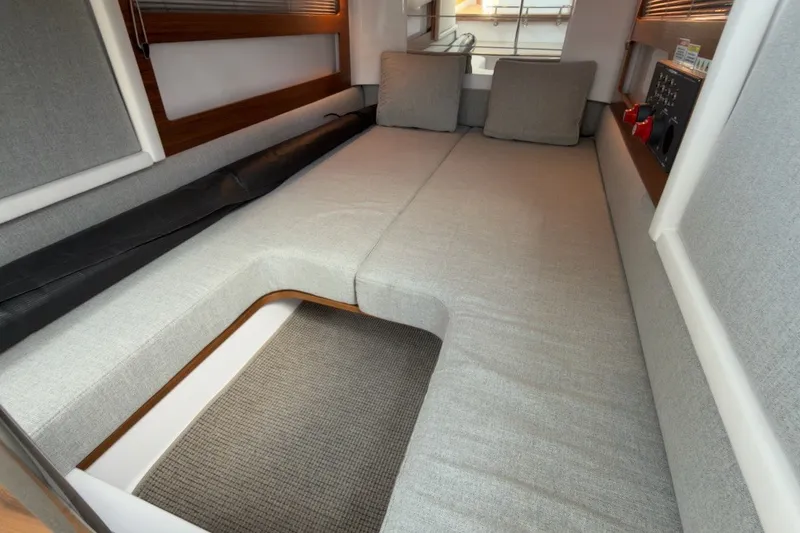 Slide: The Image of 2023 Axopar 28 Cabin interior with gray seating and modern design. - 22