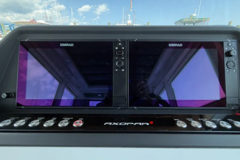 Slide: The Image of Dashboard of 2023 Axopar 28 Cabin with dual Simrad displays. - 27