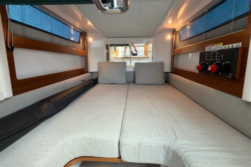 Slide: The Image of 2023 Axopar 28 Cabin interior with cozy seating and modern design. - 21