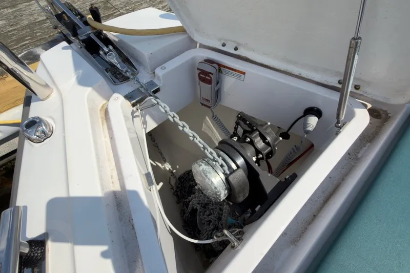 Slide: The Image of Anchor compartment of 2023 Axopar 28 Cabin boat with chain and winch. - 41