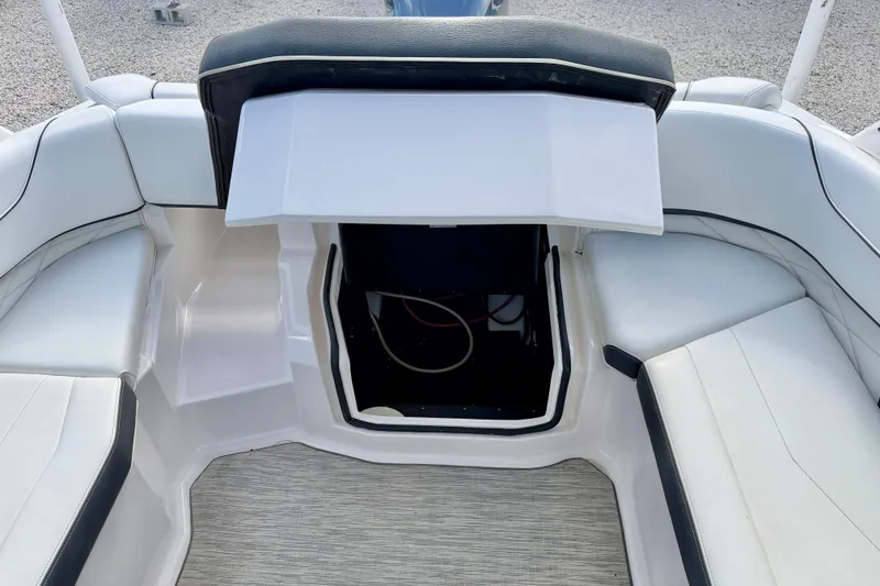 Slide: The Image of 2019 Regal 23 OBX boat interior with open storage compartment and white seating. - 36