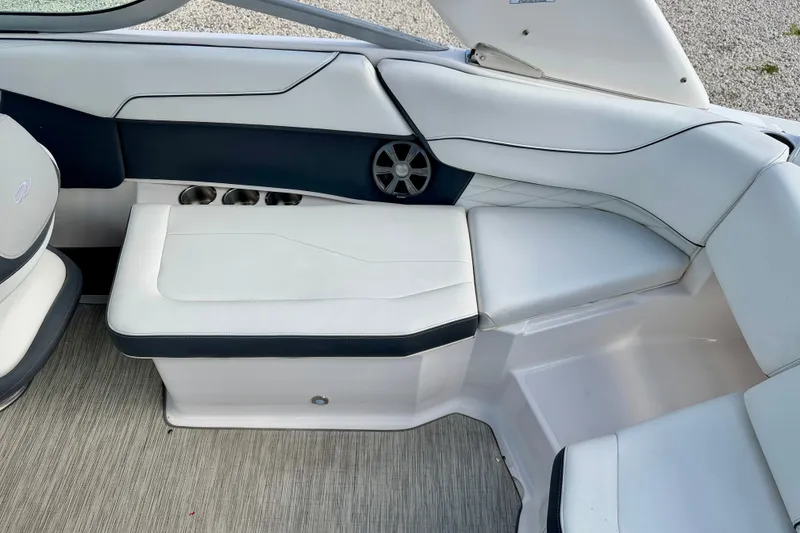 Slide: The Image of 2019 Regal 23 OBX boat interior with white seating and speaker. - 23