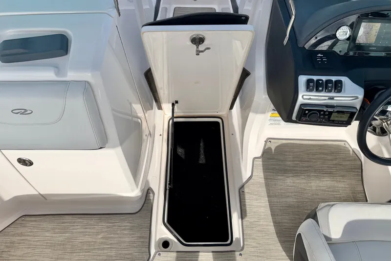 Slide: The Image of 2019 Regal 23 OBX boat interior with open storage compartment and control panel. - 34
