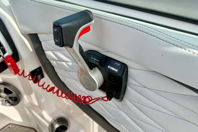 Slide: The Image of Throttle control of a 2019 Regal 23 OBX boat with Yamaha branding and red safety cord. - 19