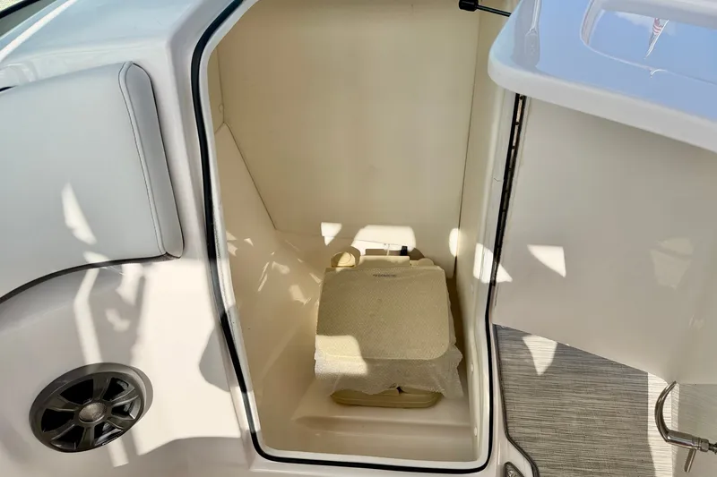 Slide: The Image of Interior storage compartment of 2019 Regal 23 OBX boat with a portable toilet. - 26