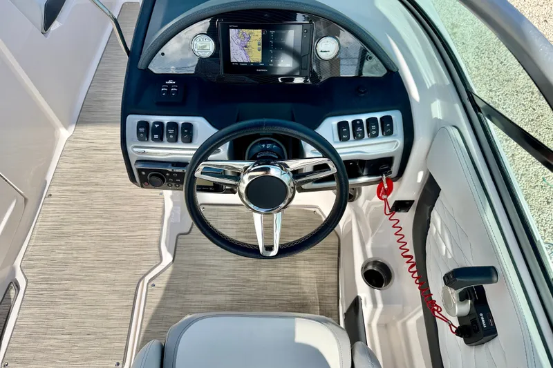 Slide: The Image of Cockpit view of 2019 Regal 23 OBX boat with steering wheel and navigation system. - 14