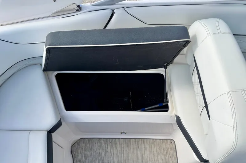Slide: The Image of Open storage compartment in 2019 Regal 23 OBX boat with cushioned seating. - 35