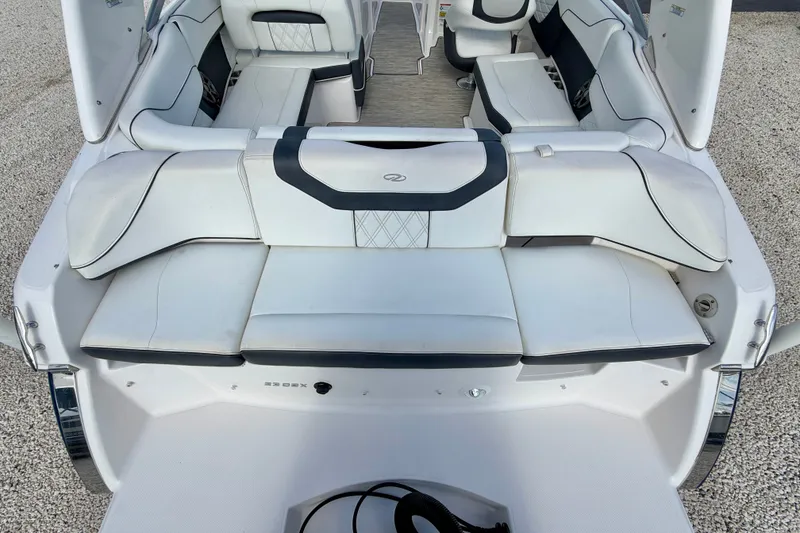 Slide: The Image of 2019 Regal 23 OBX boat interior with white cushioned seating and sleek design. - 25