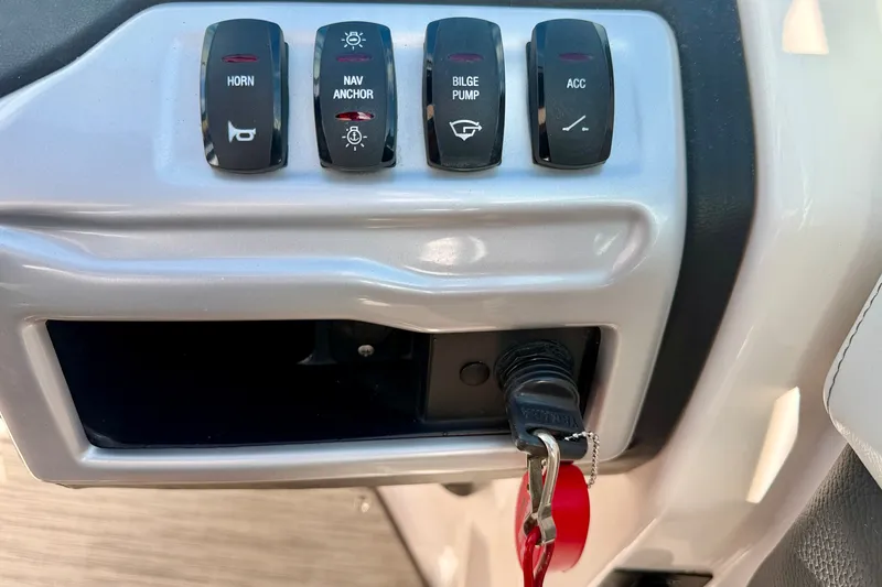 Slide: The Image of Control panel of a 2019 Regal 23 OBX boat with switches and ignition key. - 18