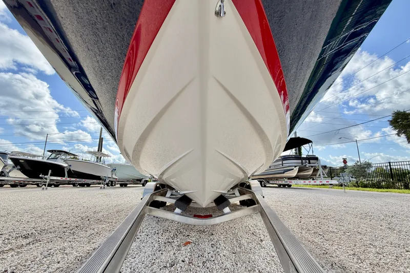 Slide: The Image of 2019 Regal 23 OBX boat on trailer, under clear blue sky. - 32