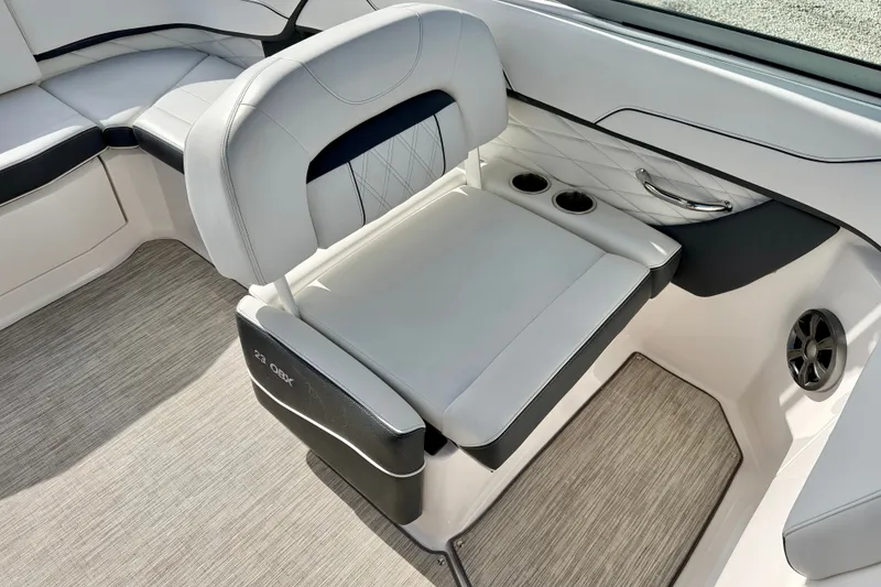 Slide: The Image of 2019 Regal 23 OBX boat interior with cushioned seating and cup holders. - 20