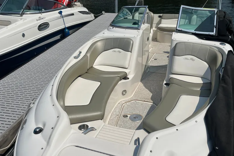 Slide: The Image of 2007 Sea Ray 240 Sundeck boat interior with cushioned seating and open deck layout. - 21