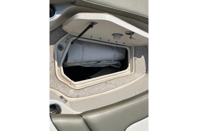 Slide: The Image of Open storage compartment on a 2007 Sea Ray 240 Sundeck boat. - 18