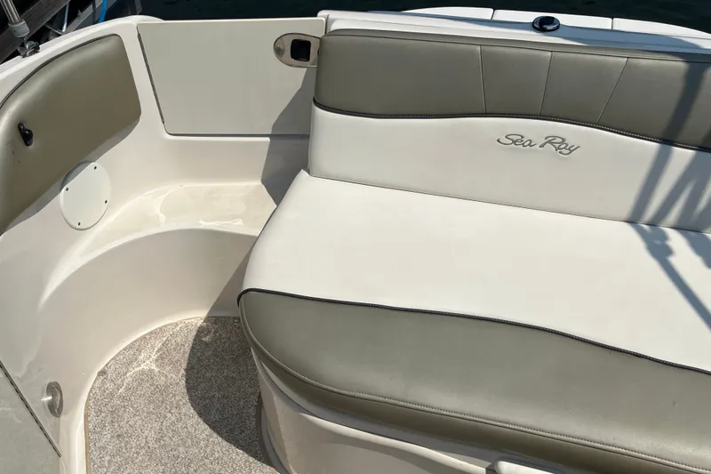 Slide: The Image of 2007 Sea Ray 240 Sundeck boat interior with cushioned seating and logo. - 25