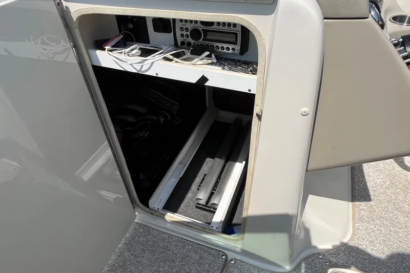 Slide: The Image of Open storage compartment on a 2007 Sea Ray 240 Sundeck boat. - 16