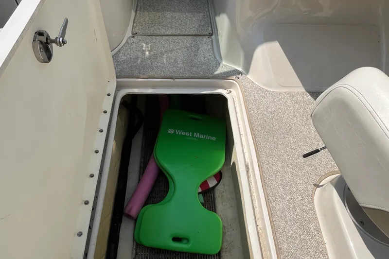 Slide: The Image of Storage compartment on a 2007 Sea Ray 240 Sundeck boat with marine equipment. - 13