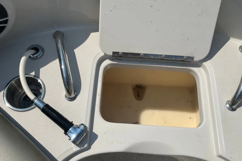 Slide: The Image of 2007 Sea Ray 240 Sundeck boat compartment with hose and storage area. - 19