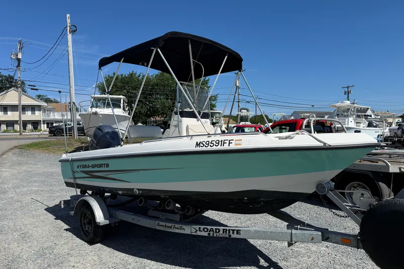 Slide: The Image of 2004 Hydra-Sports Lightning 170 CC boat on trailer, parked outdoors under clear sky. - 2