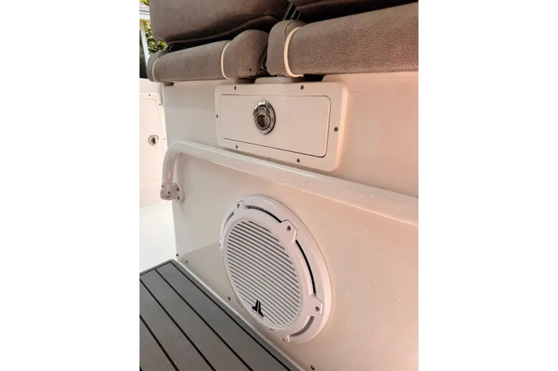 Slide: The Image of 2020 Sea Hunt Ultra 275SE boat interior with speaker and cushioned seating. - 53
