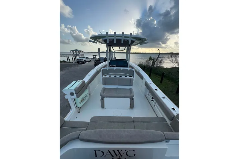 Slide: The Image of 2020 Sea Hunt Ultra 275SE boat docked at sunset with spacious seating. - 11