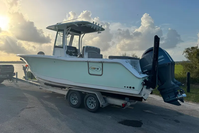 Slide: The Image of 2020 Sea Hunt Ultra 275SE boat on trailer at sunset, ready for launch. - 13
