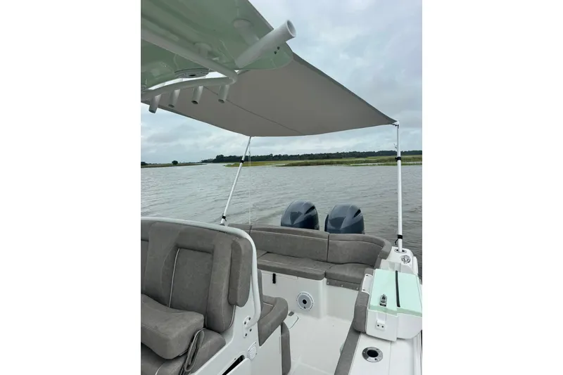 Slide: The Image of 2020 Sea Hunt Ultra 275SE boat with canopy on a calm lake. - 48