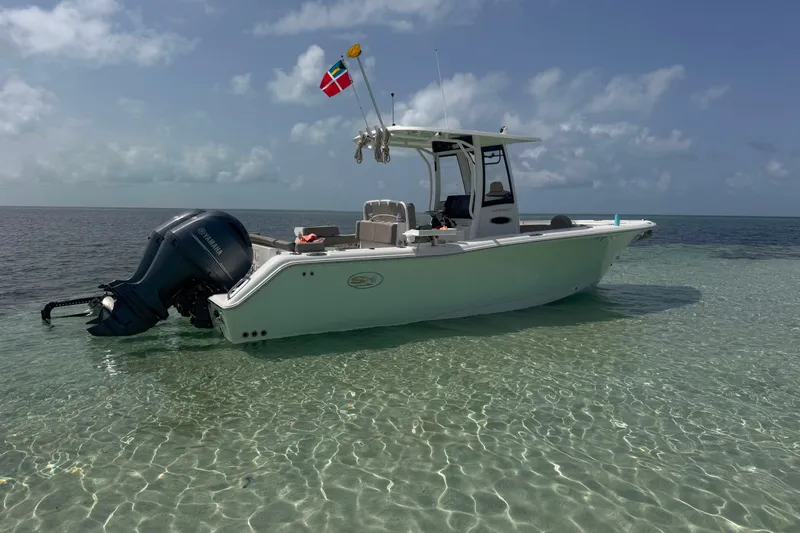 Slide: The Image of 2020 Sea Hunt Ultra 275SE boat anchored in clear shallow water under a blue sky. - 5