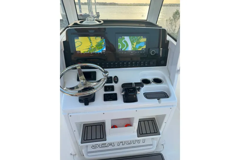 Slide: The Image of 2020 Sea Hunt Ultra 275SE boat dashboard with navigation screens and steering wheel. - 31