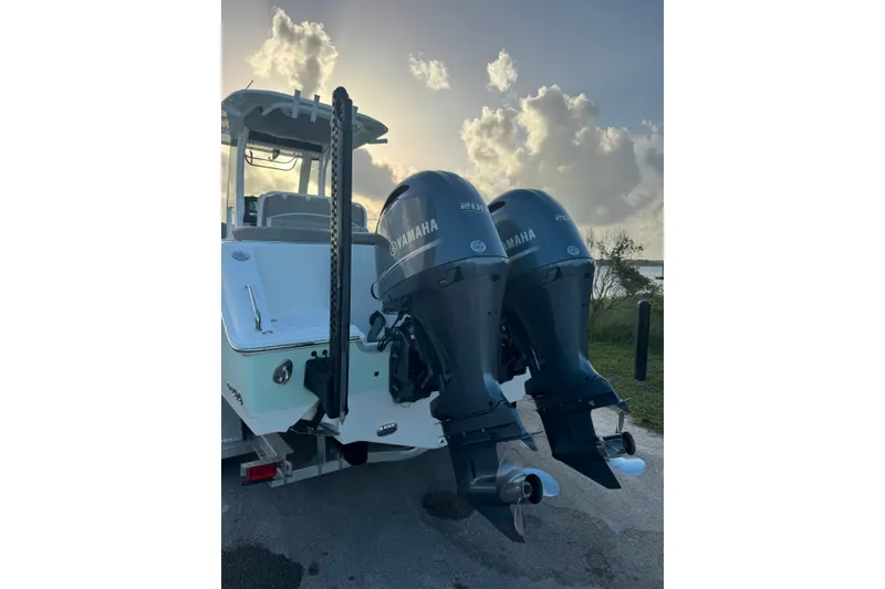 Slide: The Image of 2020 Sea Hunt Ultra 275SE boat with dual Yamaha outboard motors at sunset. - 26