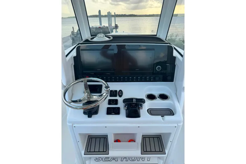 Slide: The Image of 2020 Sea Hunt Ultra 275SE boat dashboard with steering wheel and navigation controls. - 30