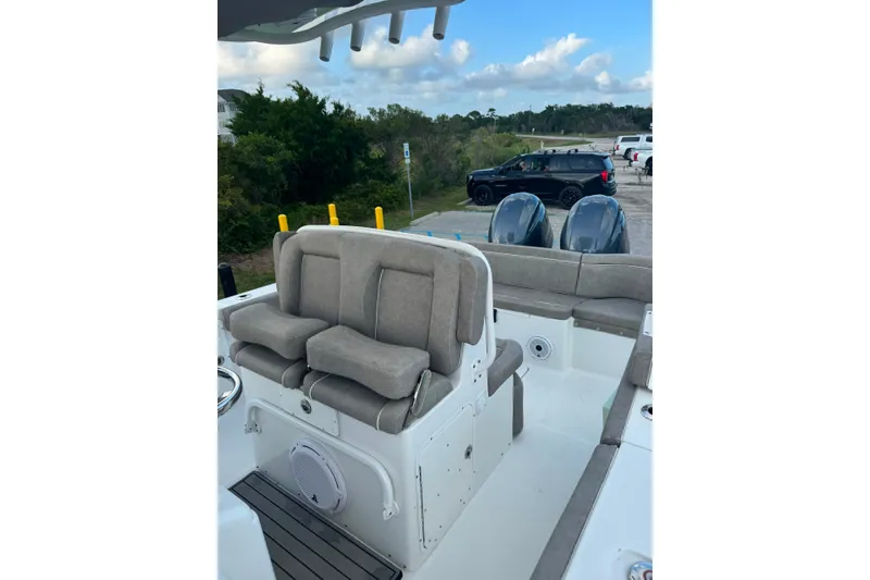 Slide: The Image of 2020 Sea Hunt Ultra 275SE boat interior with cushioned seating and dual engines. - 21