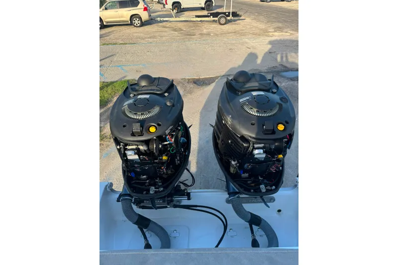 Slide: The Image of Twin outboard engines on a 2020 Sea Hunt Ultra 275SE boat, parked on a trailer. - 41