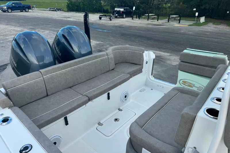 Slide: The Image of 2020 Sea Hunt Ultra 275SE boat interior with dual Yamaha engines and cushioned seating. - 23