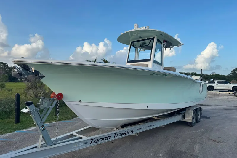 Slide: The Image of 2020 Sea Hunt Ultra 275SE boat on trailer under blue sky. - 10