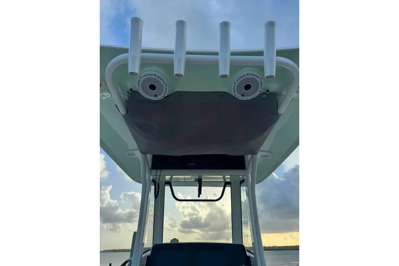 Slide: The Image of 2020 Sea Hunt Ultra 275SE boat with rod holders and speakers under the canopy. - 19
