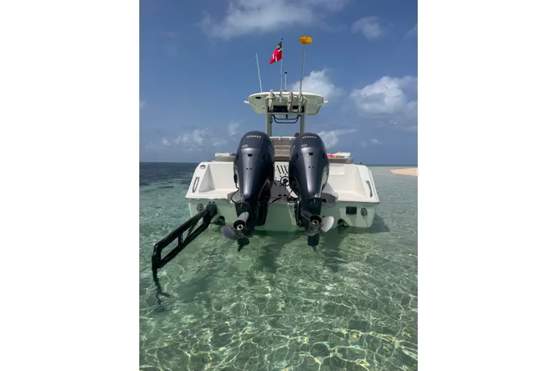 Slide: The Image of 2020 Sea Hunt Ultra 275SE boat with dual engines in clear shallow water. - 6