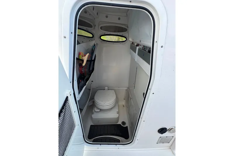 Slide: The Image of Interior view of 2020 Sea Hunt Ultra 275SE boat's compact bathroom. - 46