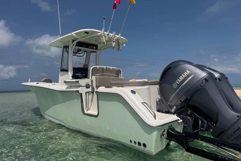 Slide: The Image of 2020 Sea Hunt Ultra 275SE boat with Yamaha engine in clear shallow water. - 12