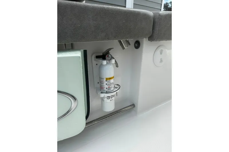 Slide: The Image of Fire extinguisher mounted on 2020 Sea Hunt Ultra 275SE boat interior. - 50