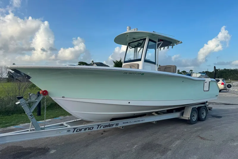 Slide: The Image of 2020 Sea Hunt Ultra 275SE boat on trailer under blue sky. - 2