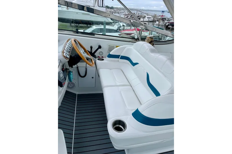 Slide: The Image of 2006 Formula 400 Super Sport boat interior with white seating and wooden steering wheel. - 13