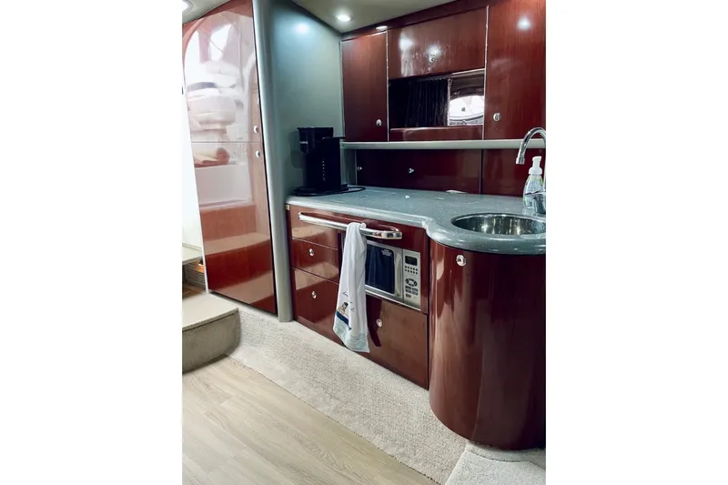 Slide: The Image of Luxurious 2006 Formula 400 Super Sport yacht interior kitchen with wood cabinetry and modern appliances. - 25
